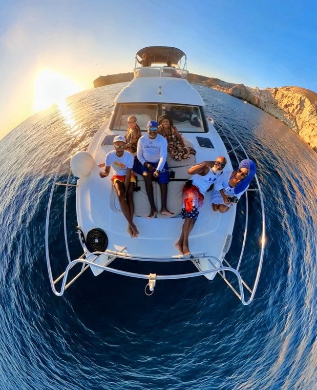 A group aboard a catamaran on a sunset cruise in the Greek islands.