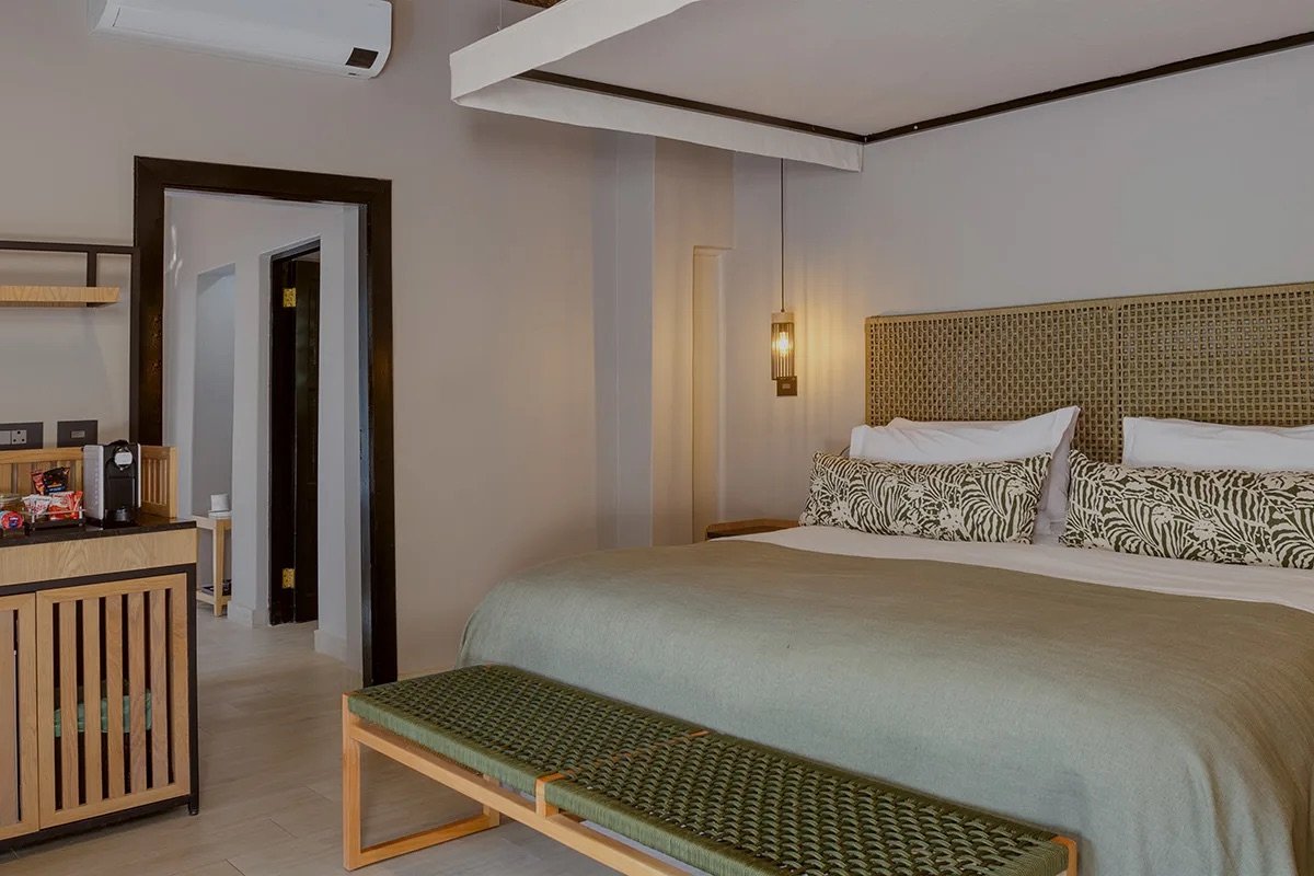 A guest suite with natural wood furnishings at Ivory Tree Game Lodge in Pilanesberg.
