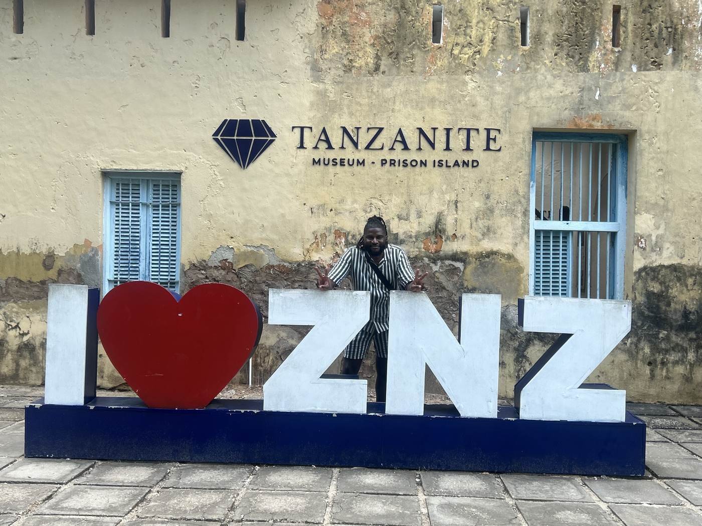 Nick beside an I Love Zanzibar sign