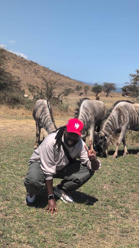 Nick with wildebeest grazing